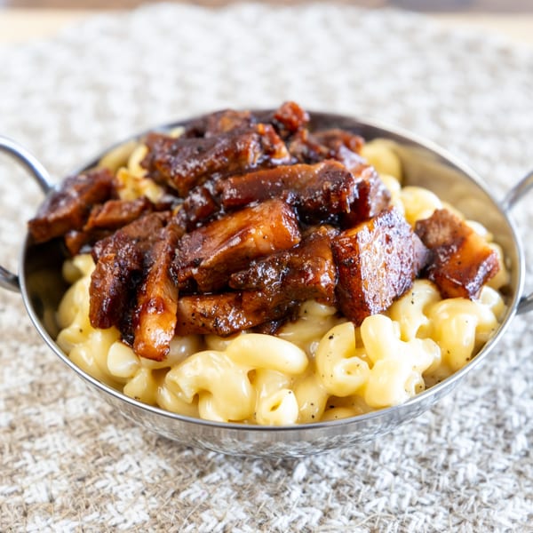 Smoke Shack BBQ's mac and cheese topped with generous chunks of saucy, dark brown brisket burnt ends.