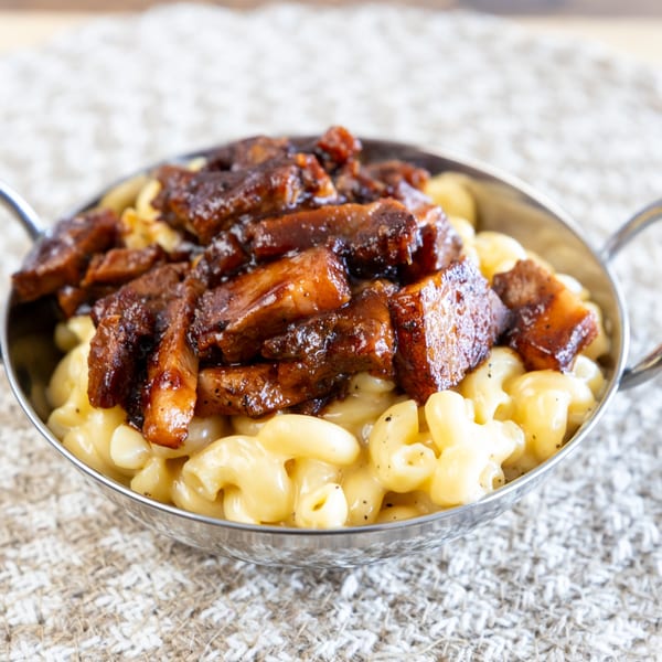 Smoke Shack BBQ's mac and cheese topped with generous chunks of dark, glazed barbecue meat.